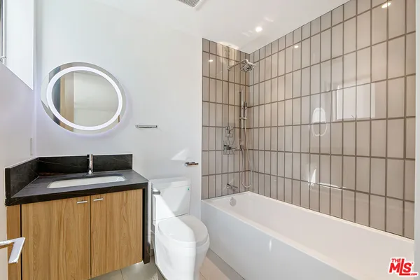 a large bathroom with double vanity and a bathtub
