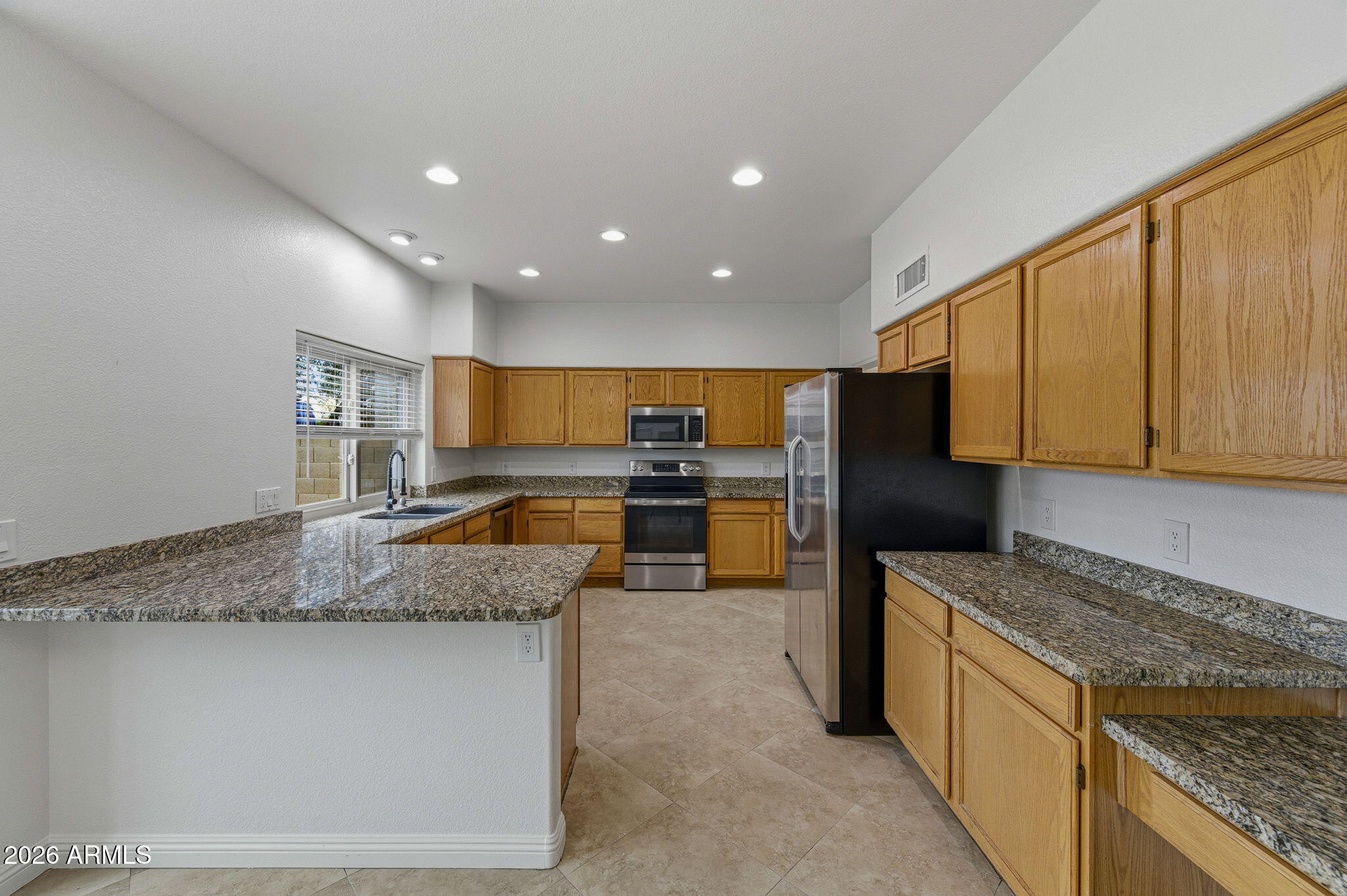 16601 South 15th Street Phoenix, AZ 85048 - Photo 18 of 62 a kitchen with stainless steel appliances granite countertop a sink stove and refrigerator