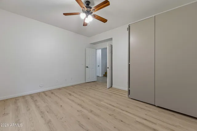 a view of staircase with railing and white walls