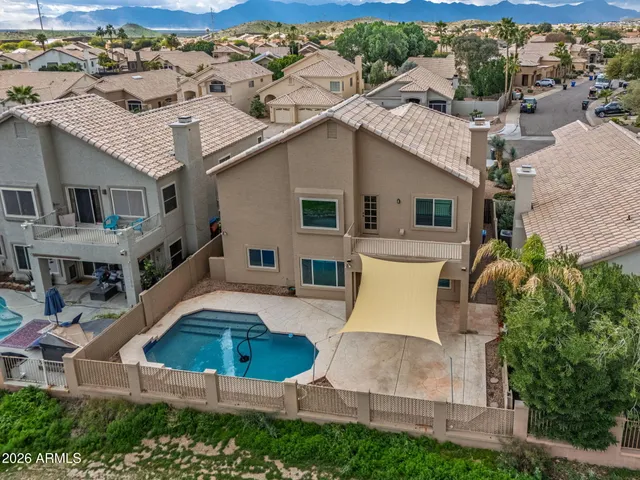 an aerial view of a residential apartment building with outdoor space and a pool