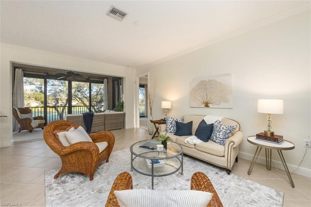 770 Regency Reserve Circle, Unit 1803 Naples, FL 34119 - Photo 13 of 35 Tiled living area featuring crown molding and baseboards