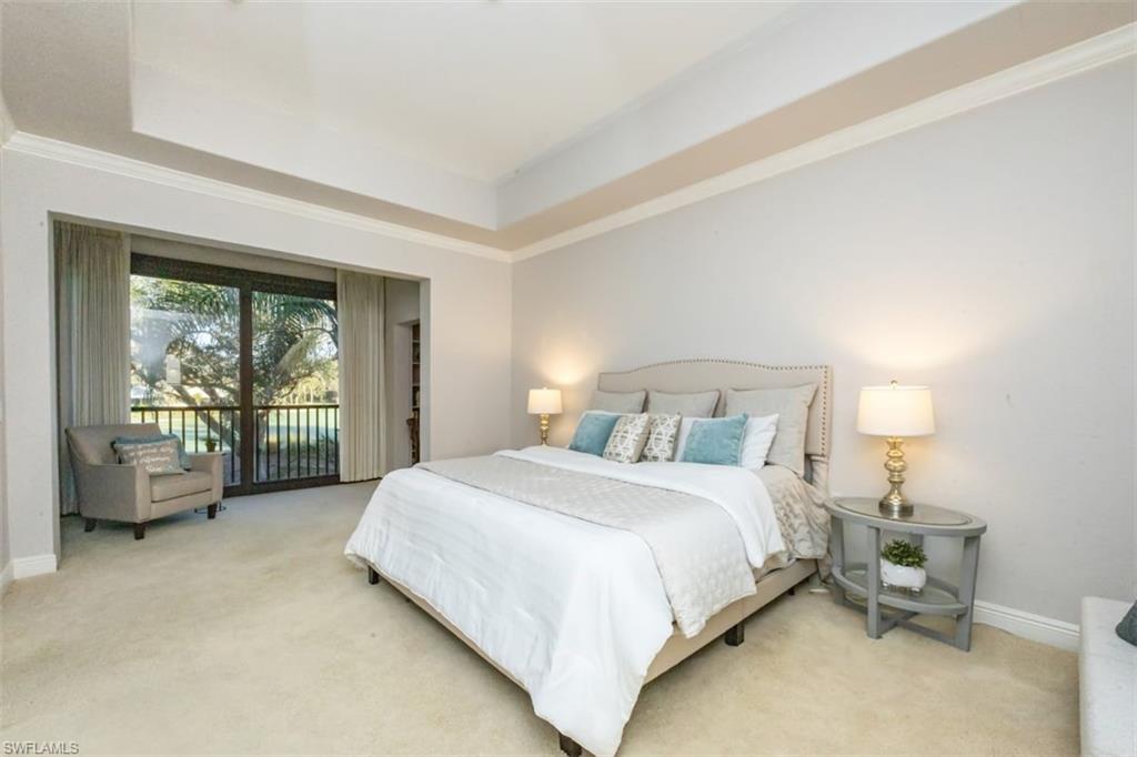 770 Regency Reserve Circle, Unit 1803 Naples, FL 34119 - Photo 13 of 35 a bedroom with a bed and large windows