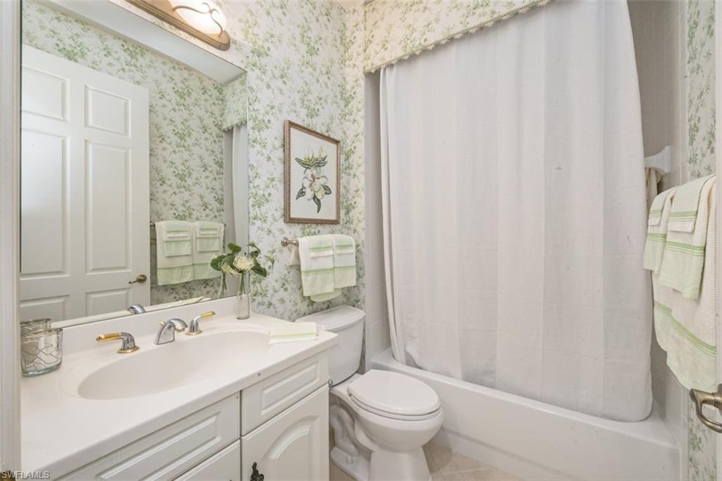 770 Regency Reserve Circle, Unit 1803 Naples, FL 34119 - Photo 18 of 35 a bathroom with a sink toilet and shower