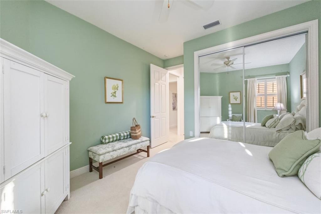 770 Regency Reserve Circle, Unit 1803 Naples, FL 34119 - Photo 20 of 35 Bedroom with light carpet, a closet, and ceiling fan