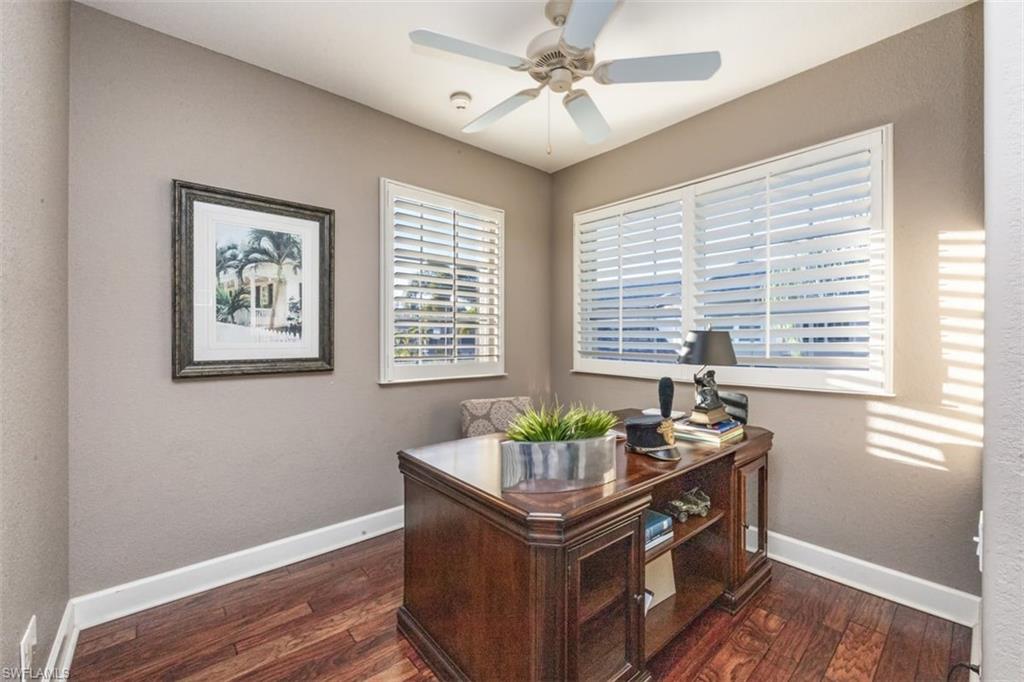 770 Regency Reserve Circle, Unit 1803 Naples, FL 34119 - Photo 5 of 35 a room with chandelier and wooden floor