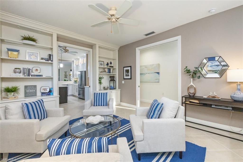 770 Regency Reserve Circle, Unit 1803 Naples, FL 34119 - Photo 8 of 35 Living area featuring built in shelves, light tile patterned floors, and ceiling fan