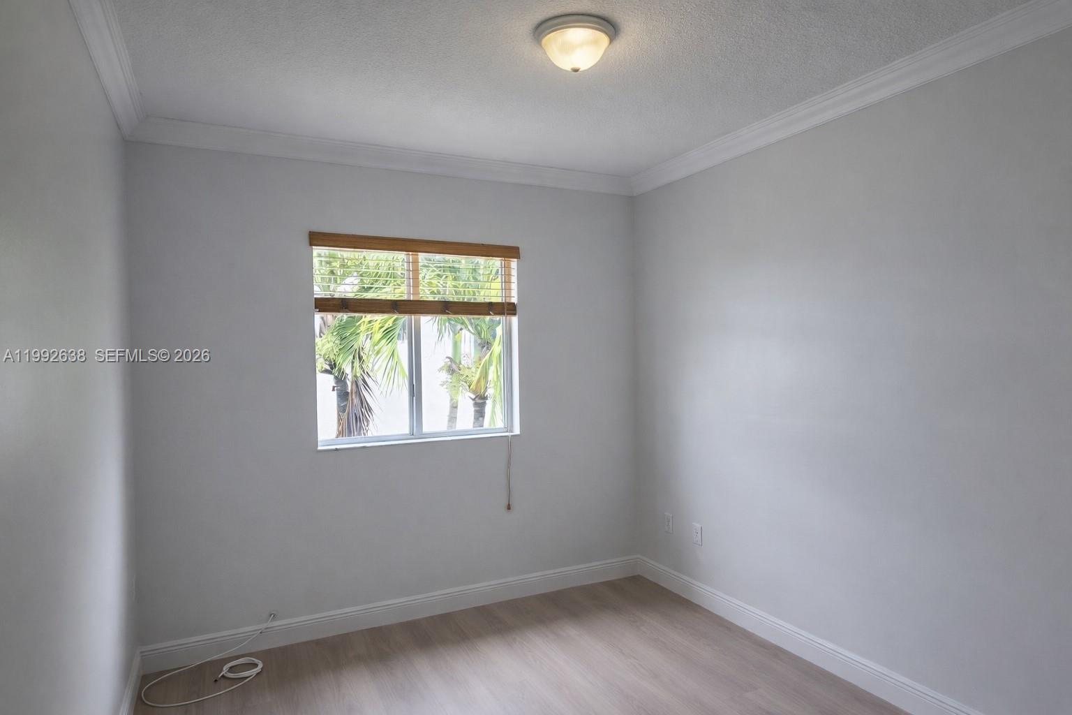 8421 Southwest 124th Avenue, Unit 101 Miami, FL 33183 - Photo 11 of 20 an empty room with a window