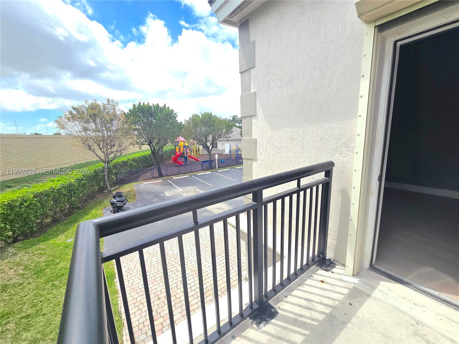 8421 Southwest 124th Avenue, Unit 101 Miami, FL 33183 - Photo 19 of 20 a view of a balcony with an outdoor space