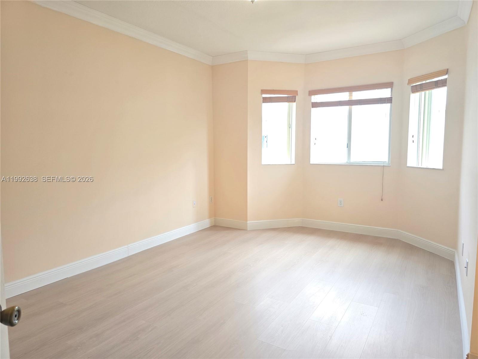 8421 Southwest 124th Avenue, Unit 101 Miami, FL 33183 - Photo 3 of 20 an empty room with a window