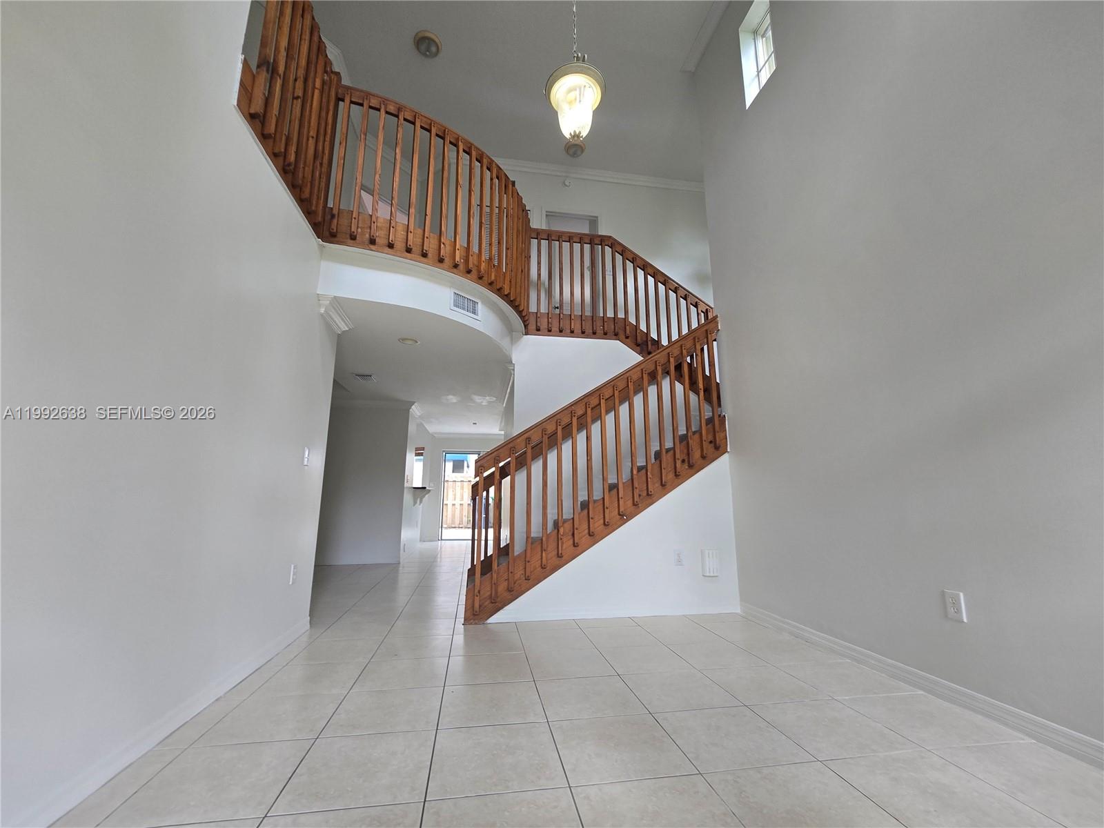 8421 Southwest 124th Avenue, Unit 101 Miami, FL 33183 - Photo 5 of 20 a view of staircase with railing and white walls