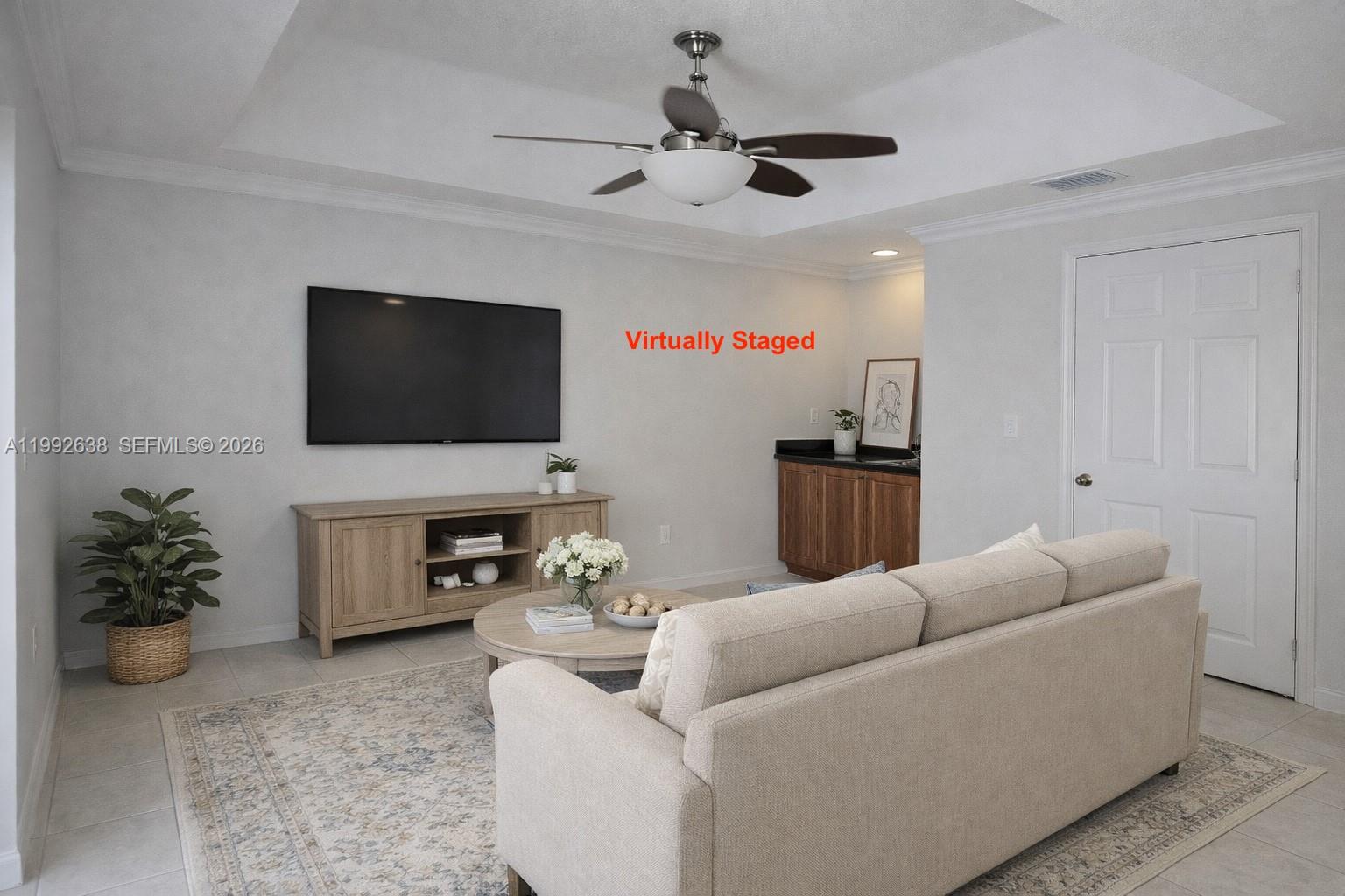 8421 Southwest 124th Avenue, Unit 101 Miami, FL 33183 - Photo 6 of 20 a living room with furniture and a flat screen tv