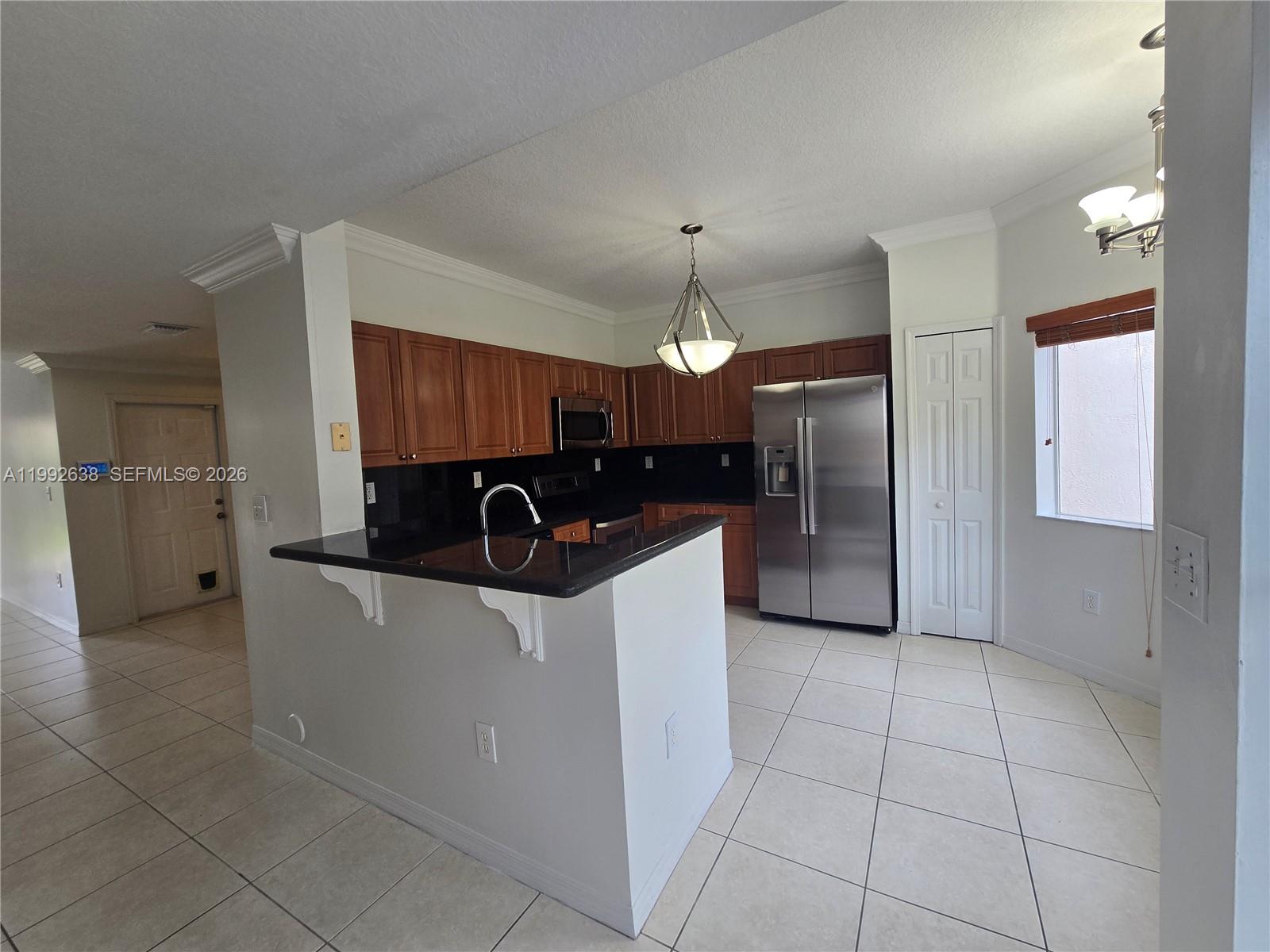 8421 Southwest 124th Avenue, Unit 101 Miami, FL 33183 - Photo 9 of 20 a large kitchen with cabinets and stainless steel appliances
