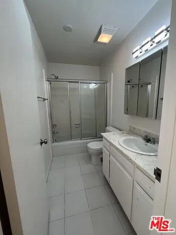 a view of a room with rack on the wall and a window