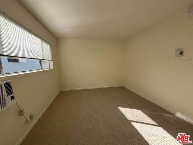 a view of a small space with wooden floor and white walls