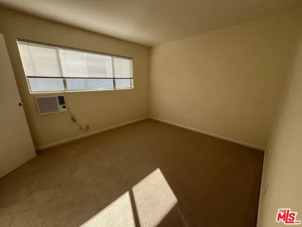 a view of an empty room and wooden floor
