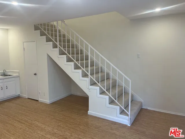 a view of a kitchen with a sink and a stove top oven