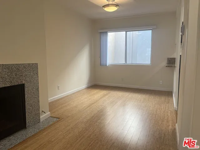 a kitchen with granite countertop a sink cabinets and stainless steel appliances