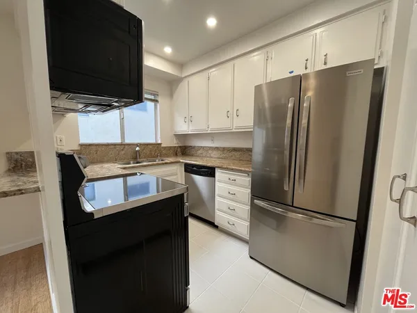 a kitchen with stainless steel appliances a refrigerator stove and microwave