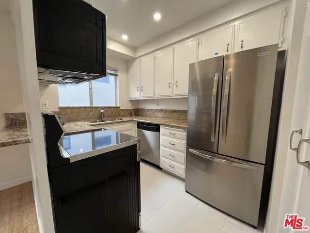 a kitchen with stainless steel appliances a refrigerator stove and microwave
