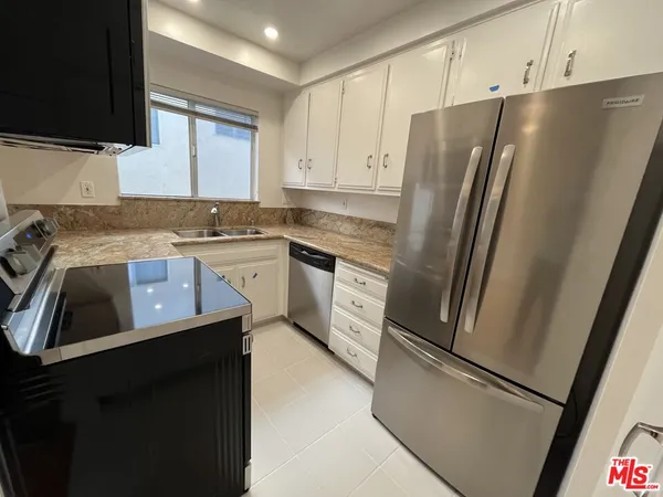 a kitchen with a refrigerator sink and stove