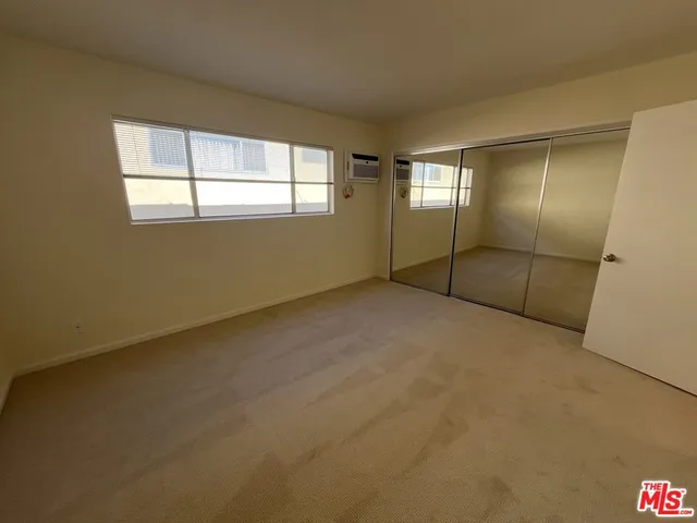 a bathroom with a granite countertop toilet sink and mirror
