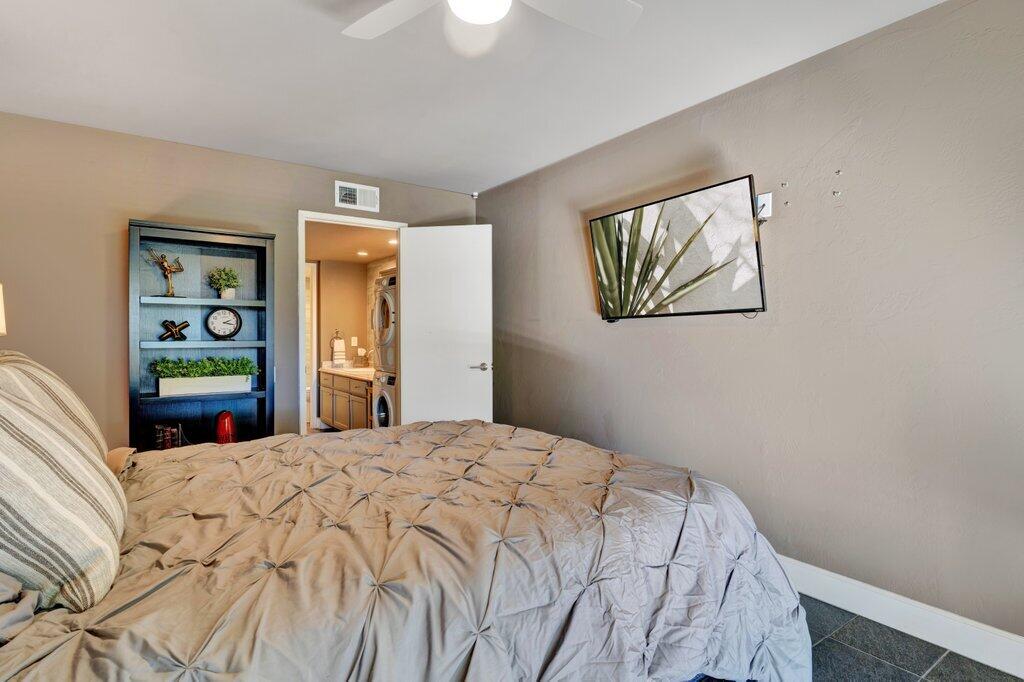 1050 Ramon Road, Unit 3 Palm Springs, CA 92264 - Photo 9 of 28 a bedroom with a bed and painting on the wall