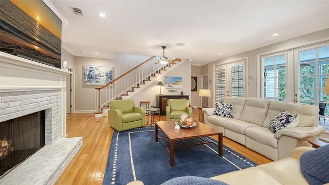 a living room with lots of furniture and a chandelier