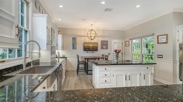 a kitchen with stainless steel appliances granite countertop a stove and a sink