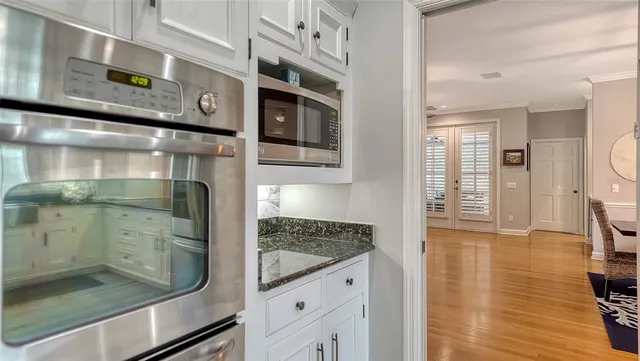 a bedroom with a large bed and a flat tv screen on dresser