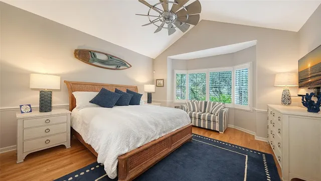 a bedroom with furniture and a large window