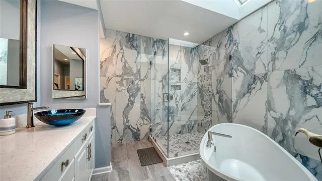 a bathroom with a granite countertop toilet sink and mirror