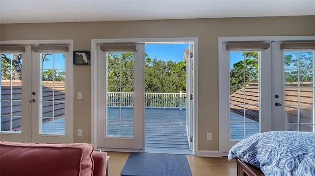 a view of a patio with a table and chairs under an umbrella