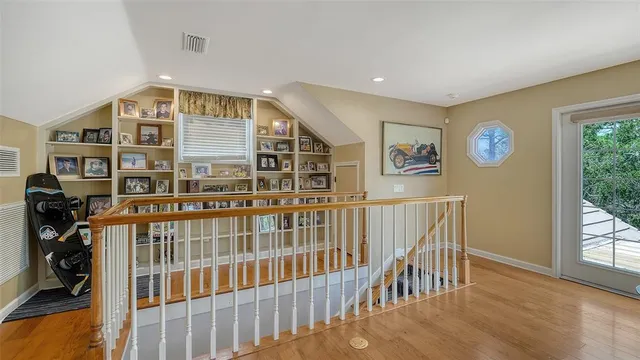 an aerial view of a house with a yard and large trees