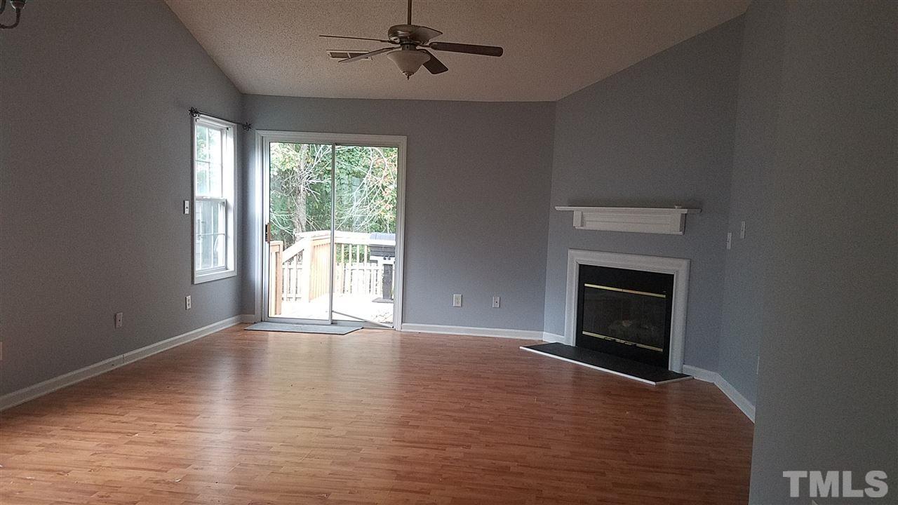 6012 Newhall Road Durham, NC 27713 - Photo 8 of 23 a view of empty room with wooden floor and fan