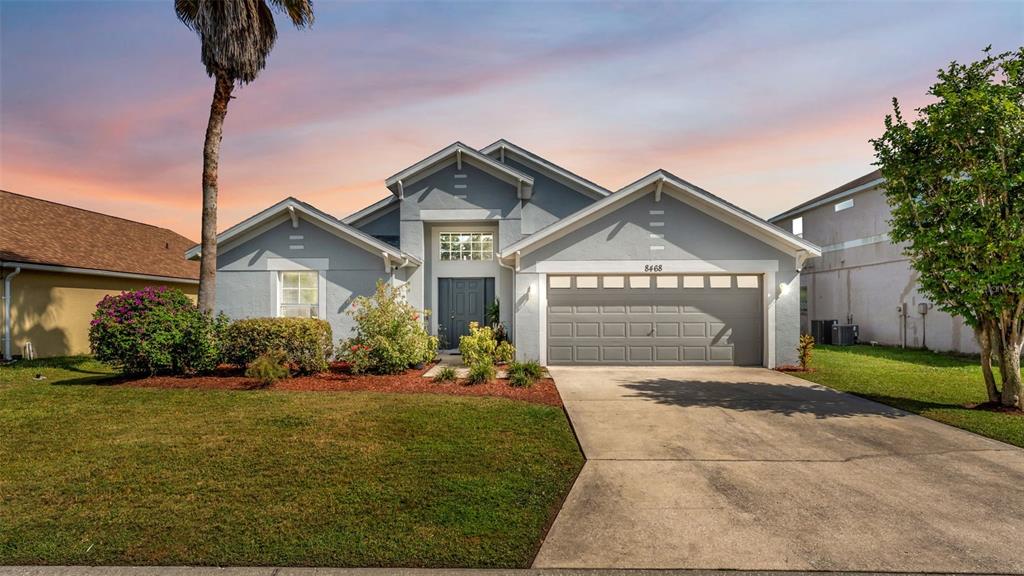 a front view of a house with a yard and garage
