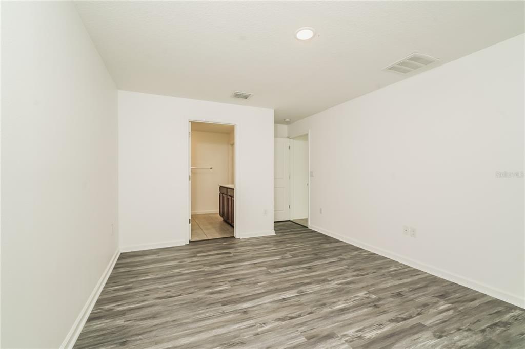 1473 Lucerne Loop Road Northeast Winter Haven, FL 33881 - Photo 10 of 25 a view of an empty room with wooden floor