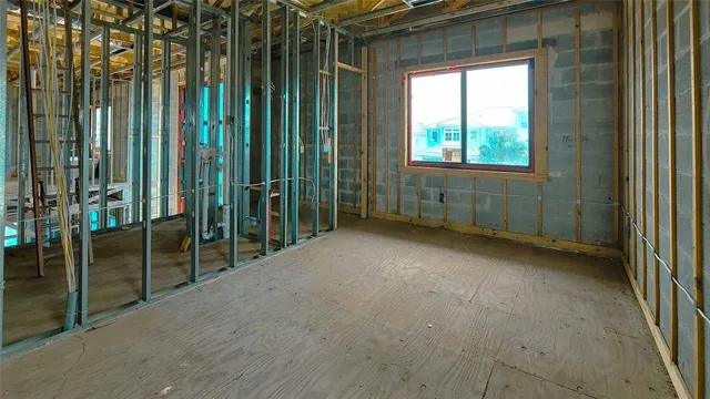 an aerial view of a house with outdoor space and lake view in back