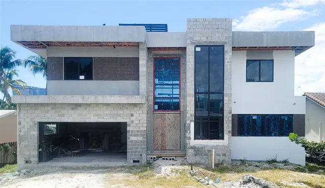 a view of a livingroom with a fireplace and kitchen view