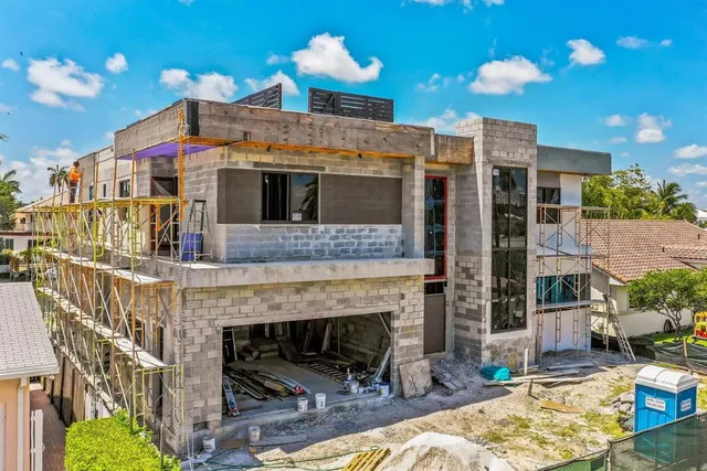 a living room with furniture a fireplace and a chandelier