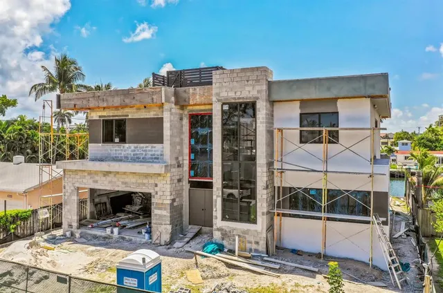 a view of a patio with table and chairs and potted plants