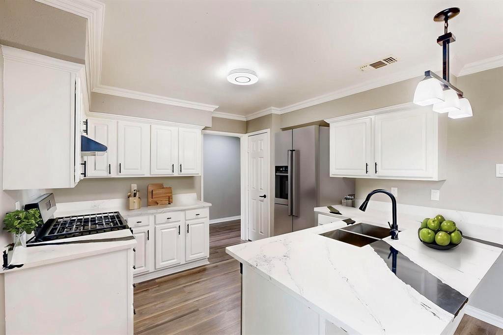 3264 Northaven Road Dallas, TX 75229 - Photo 7 of 35 *Virtually staged* Kitchen featuring a sink, light wood-style floors, white cabinetry, and crown molding