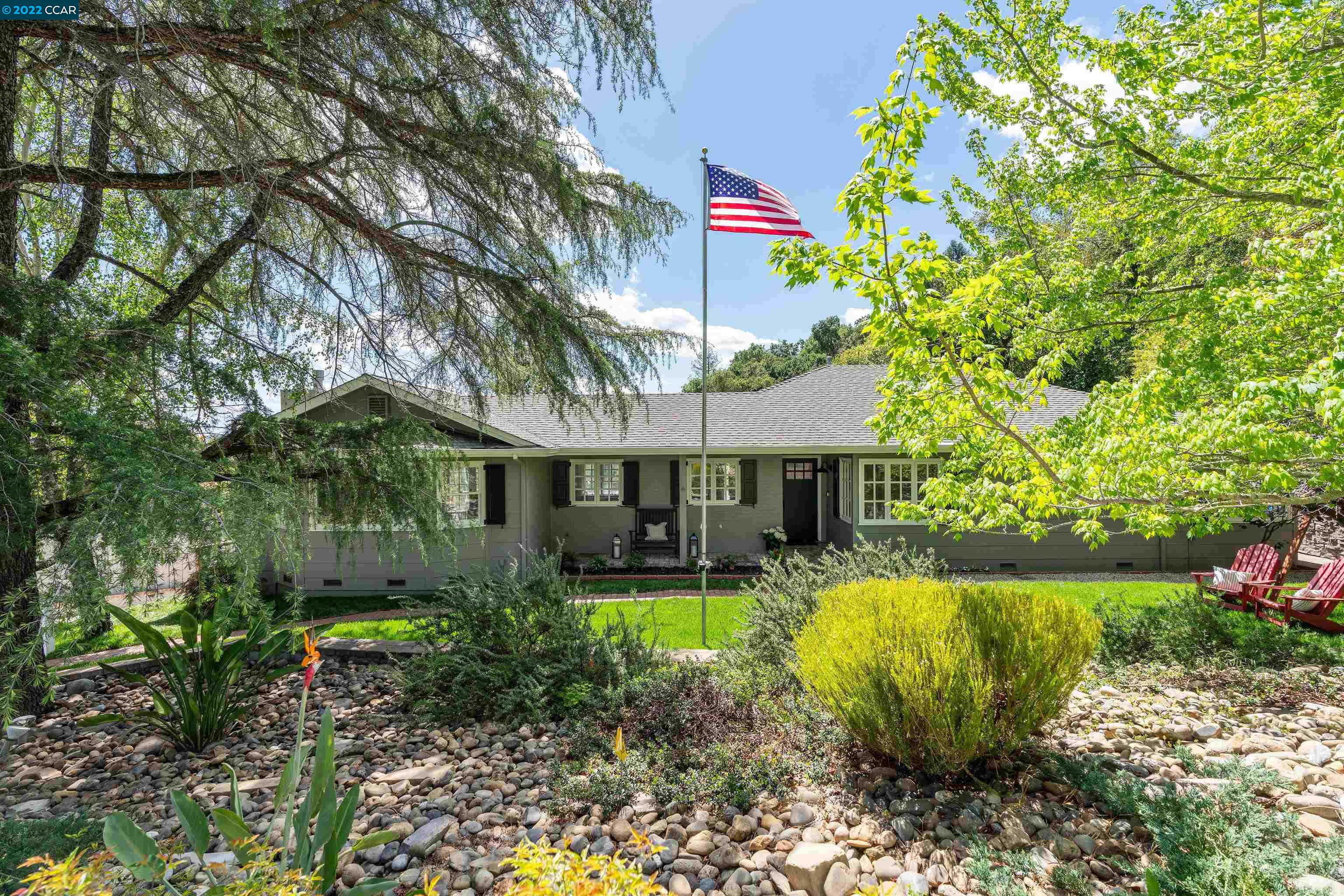 a view of a house with a yard porch and sitting area