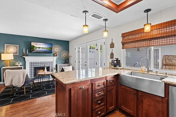 a kitchen with stainless steel appliances granite countertop a sink stove and wooden cabinets