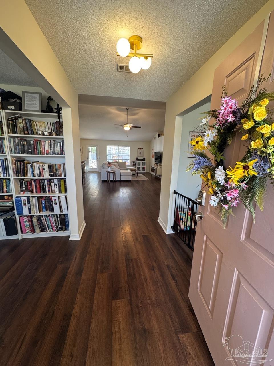 4930 Chads Circle Pace, FL 32571 - Photo 16 of 18 a living room with furniture and a book shelf