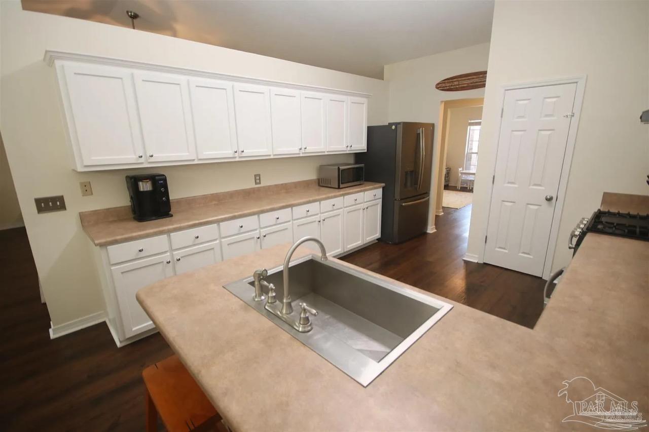 4930 Chads Circle Pace, FL 32571 - Photo 2 of 18 a kitchen with stainless steel appliances granite countertop a sink a stove and white cabinets