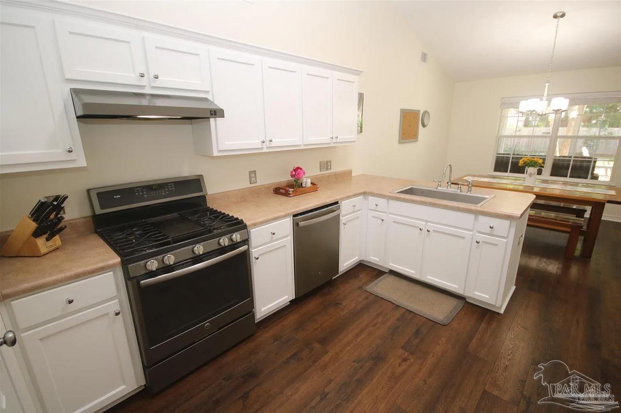 4930 Chads Circle Pace, FL 32571 - Photo 3 of 18 a kitchen with a sink stove and cabinets