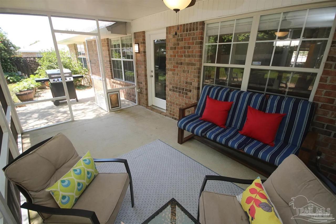 4930 Chads Circle Pace, FL 32571 - Photo 5 of 18 a living room with furniture and a floor to ceiling window