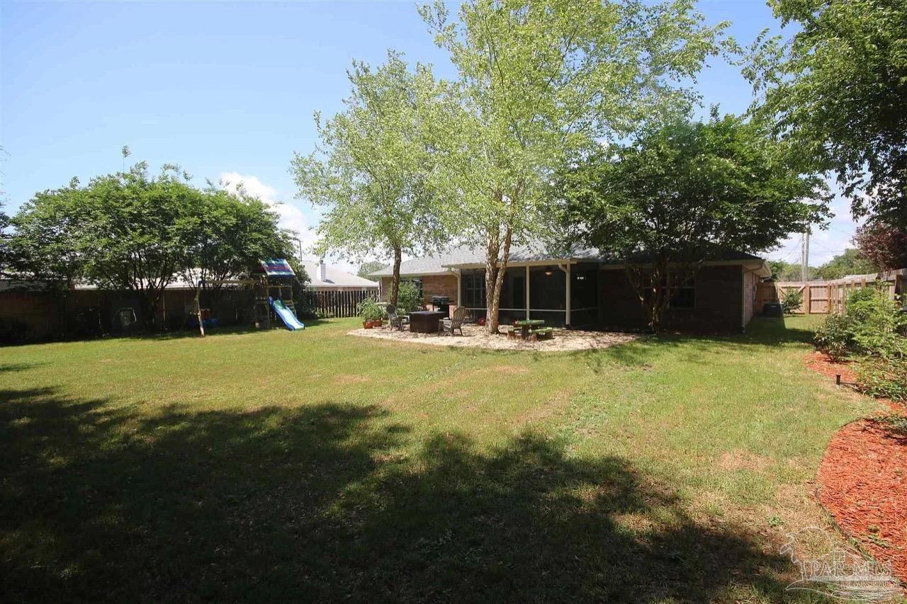 4930 Chads Circle Pace, FL 32571 - Photo 6 of 18 a swimming pool with outdoor seating and yard