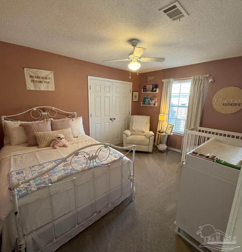 4930 Chads Circle Pace, FL 32571 - Photo 7 of 18 a bedroom with a bed and wooden floor