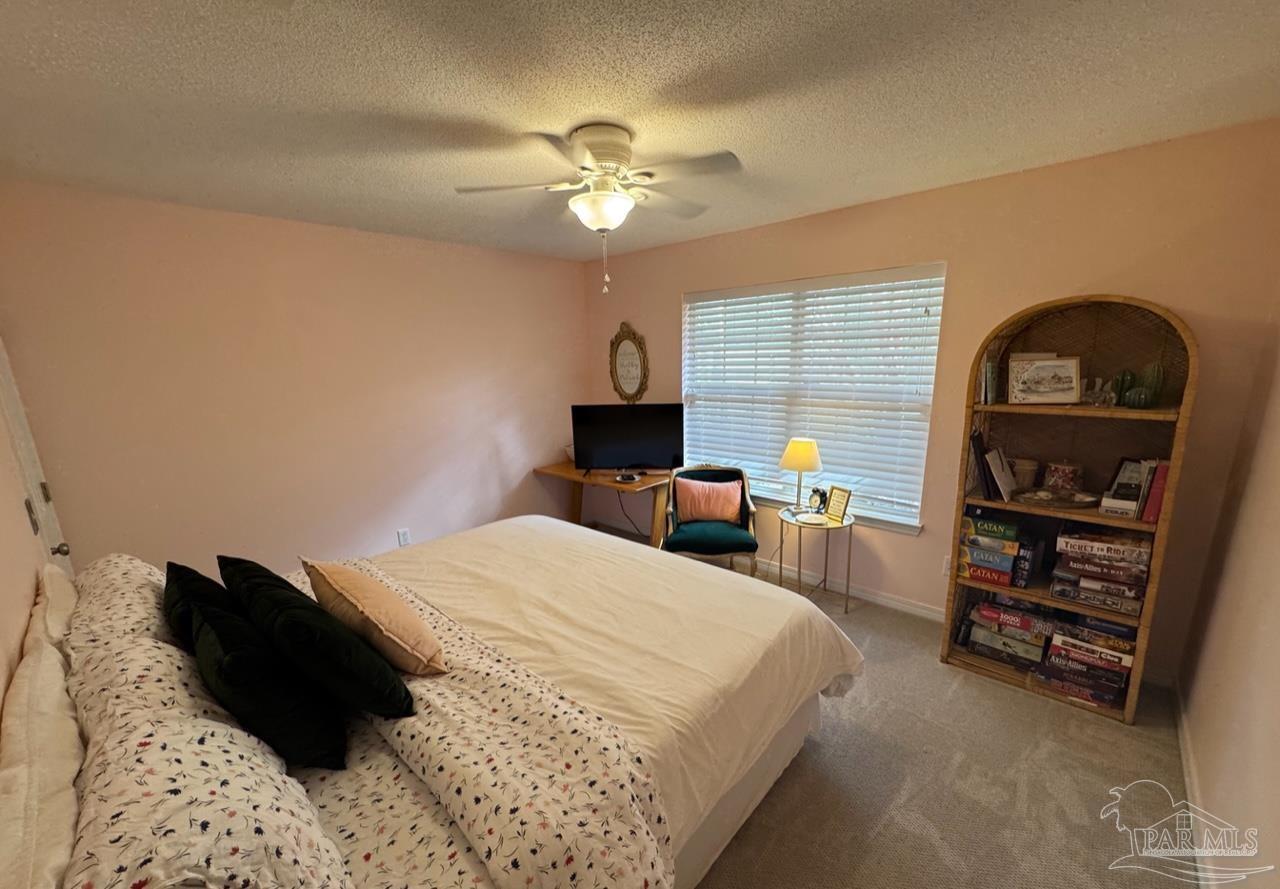 4930 Chads Circle Pace, FL 32571 - Photo 8 of 18 a bed room with a bed and a chandelier